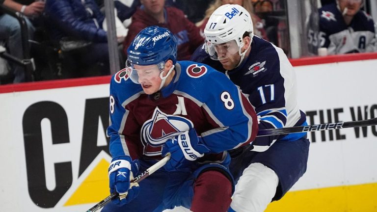 Colorado Avalanche defenceman Cale Makar collects the puck with Winnipeg Jets centre Adam Lowry in pursuit in the second period of Game 4 of an NHL Stanley Cup first-round playoff series Sunday, April 28, 2024, in Denver. (David Zalubowski/AP Photo)