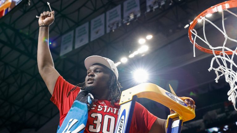 North Carolina State's DJ Burns Jr. cuts the net following an Elite Eight college basketball game against Duke in the NCAA Tournament in Dallas, Sunday, March 31, 2024. (Brandon Wade/AP Photo)