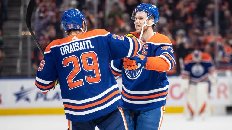 Edmonton Oilers' Connor McDavid (97) and Leon Draisaitl (29) celebrate a goal against the Arizona Coyotes during overtime NHL action in Edmonton on Wednesday March 22, 2023. (Jason Franson/CP)