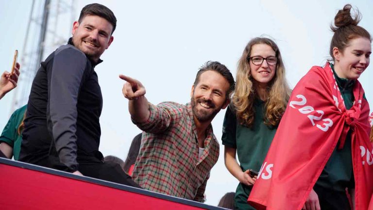 Wrexham co-owner Ryan Reynolds, center, celebrates with members of the Wrexham FC soccer team the promotion to the Football League in Wrexham, Wales, Tuesday, May 2, 2023. (Jon Super/AP)