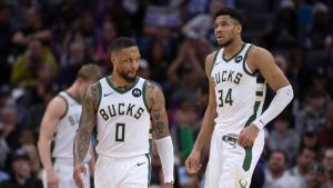 Milwaukee Bucks guard Damian Lillard (0) and forward Giannis Antetokounmpo (34) walk toward the bench during a timeout in the second half of the team's NBA basketball game against the Sacramento Kings in Sacramento, Calif., Tuesday, March 12, 2024. The Kings won 129-94. (José Luis Villegas/AP)