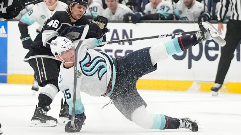 Seattle Kraken left wing Andre Burakovsky, right, falls in from of Los Angeles Kings center Blake Lizotte during the first period of an NHL hockey game Wednesday, April 3, 2024, in Los Angeles. (AP)