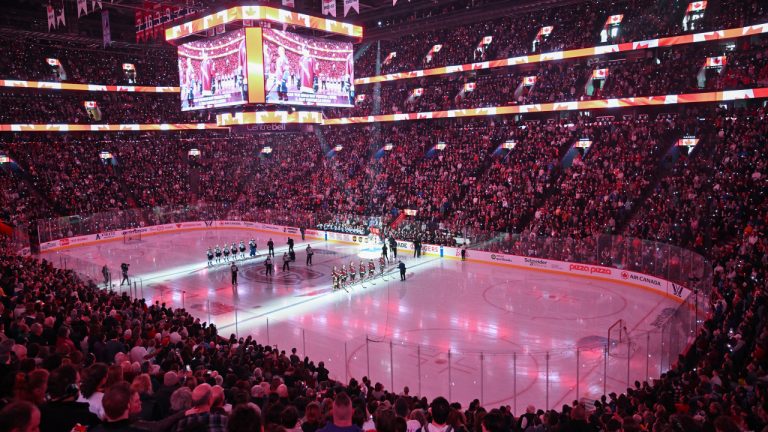 Fans look on as players from PWHL Montreal and Toronto stand for the national anthem ahead of their PWHL hockey game at the Bell Centre in Montreal, Saturday, April 20, 2024. (Graham Hughes/CP)