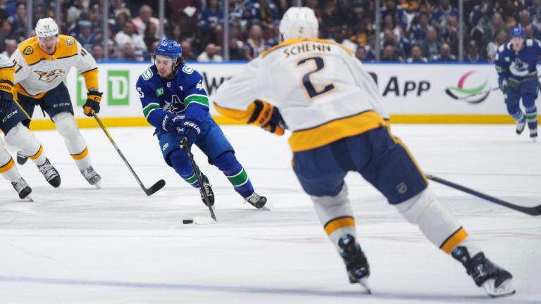 Vancouver Canucks' Quinn Hughes (43) skates with the puck past Nashville Predators' Cole Smith and Michael McCarron (47) as Luke Schenn (2) watches during the first period in Game 2 of an NHL hockey Stanley Cup first-round playoff series, in Vancouver, on Tuesday, April 23, 2024. (Darryl Dyck/CP)