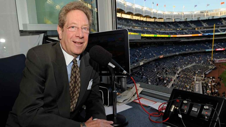 In this photo taken on Friday, Sept. 25, 2009, New York Yankees broadcaster John Sterling sits his booth before a baseball game against the Boston Red Sox at Yankee Stadium in New York. Sterling has been the distinctive voice of the Yankees for 20 years, the heir to one of the most coveted and influential seats in sports radio.(Bill Kostroun/AP)