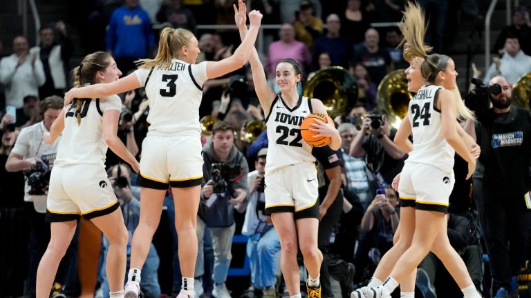 Iowa guard Caitlin Clark (22) celebrates with teammates after defeating LSU in an Elite Eight round college basketball game during the NCAA Tournament, Monday, April 1, 2024, in Albany, N.Y. (Mary Altaffer/AP)