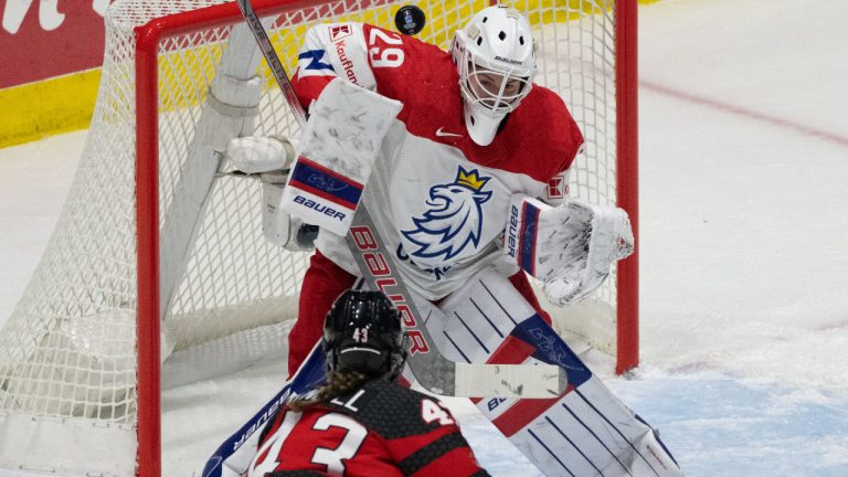 Canada's Kristin O'Neill (43) takes a shot on Czechia goaltender Klara Peslarova (29) during first period hockey action at the IIHF Women's World Hockey Championship in Utica, N.Y., Sunday, April 7, 2024. (Christinne Muschi/CP)