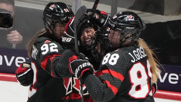 Canada's Renata Fast, centre, celebrates her goal over Sweden with teammates Danielle Serdachny (92) and Julia Gosling (88) during first period quarter final hockey action at the IIHF Women's World Hockey Championship in Utica, N.Y., Thursday, April 11, 2024. (CP/Christinne Muschi)