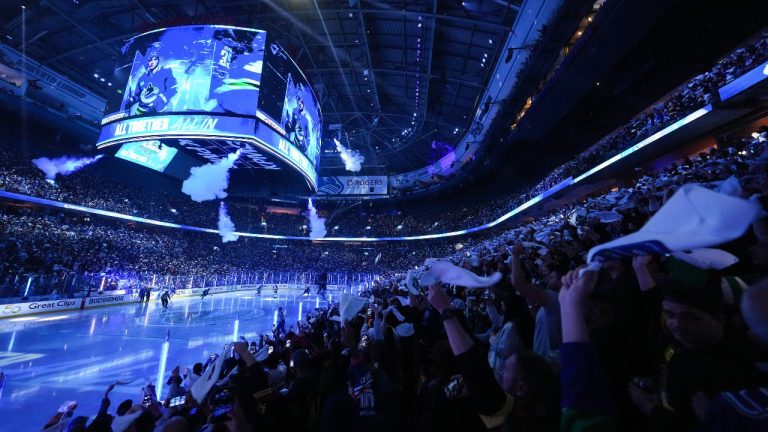 Fans wave towels before the Vancouver Canucks and Nashville Predators play Game 1 of an NHL hockey Stanley Cup first-round playoff series, in Vancouver, on Sunday, April 21, 2024. (Darryl Dyck/CP)