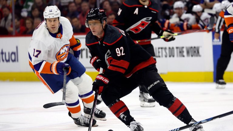 Carolina Hurricanes' Evgeny Kuznetsov (92) controls the puck in front of New York Islanders' Matt Martin (17) during the second period in Game 2 of an NHL hockey Stanley Cup first-round playoff series in Raleigh, N.C., Monday, April 22, 2024. (Karl B DeBlaker/AP)