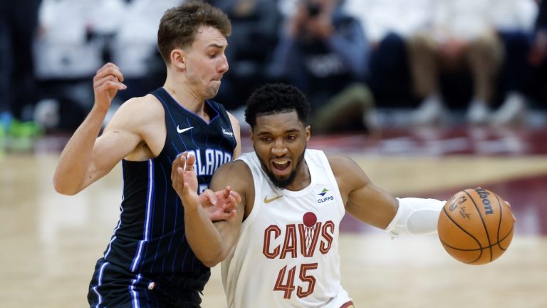 Cleveland Cavaliers guard Donovan Mitchell (45) drives against Orlando Magic forward Franz Wagner during the first half of Game 2 of an NBA basketball first-round playoff series, Monday, April 22, 2024, in Cleveland. (AP Photo/Ron Schwane)