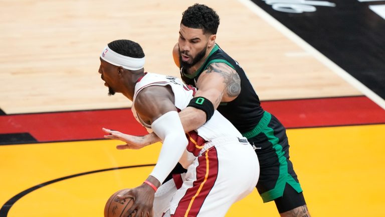 Boston Celtics forward Jayson Tatum (0) attempts to knock the ball away from Miami Heat center Bam Adebayo during the first half of Game 3 of an NBA basketball first-round playoff series, Saturday, April 27, 2024, in Miami. (AP Photo/Wilfredo Lee)