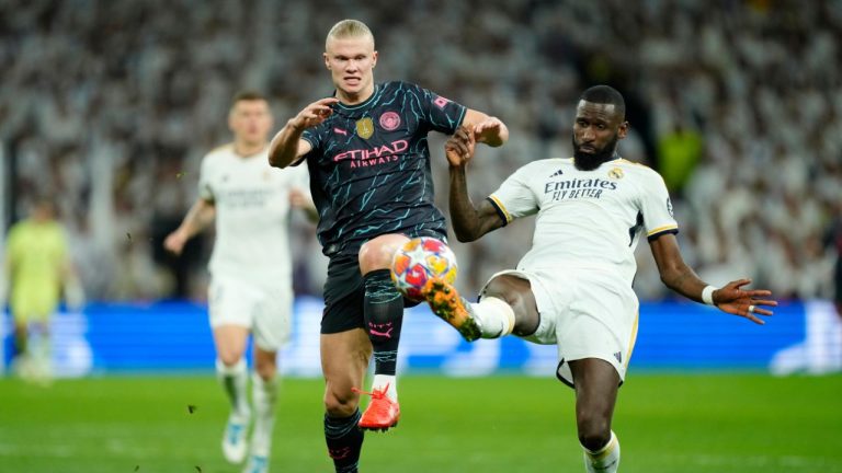 Real Madrid's Antonio Rudiger fights for the ball with Manchester City's Erling Haaland during the Champions League quarterfinal first leg soccer match between Real Madrid and Manchester City at the Santiago Bernabeu stadium in Madrid, Spain, Tuesday, April 9, 2024. (Jose Breton/AP Photo)