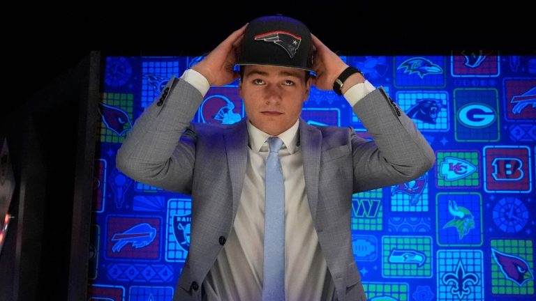 North Carolina quarterback Drake Maye puts on a hat after being chosen by the New England Patriots with the third overall pick during the first round of the NFL football draft, Thursday, April 25, 2024, in Detroit. (Jeff Roberson/AP Photo)