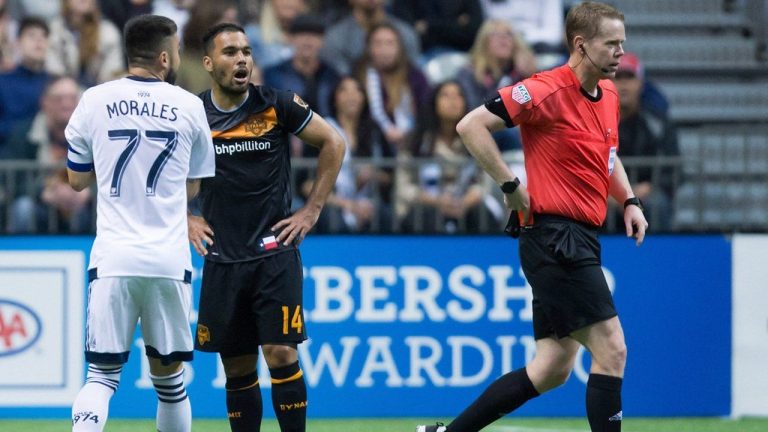 Canadian Drew Fischer is one of 21 FIFA referees appointed to work the football tournament at this summer's Paris Olympics. (Houston Dynamo's Alex, second left, and Vancouver Whitecaps' Pedro Morales, left, react after both received red cards from referee Drew Fischer during the first half of an MLS soccer game in Vancouver on Saturday May 28, 2016.  (Darryl Dyck/CP)