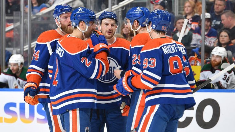 Leon Draisaitl, Zach Hyman, Mattias Ekholm, Evan Bouchard and Ryan Nugent-Hopkins of the Edmonton Oilers discuss the play during the game against the Arizona Coyotes. (Andy Devlin/NHLI via Getty Images)