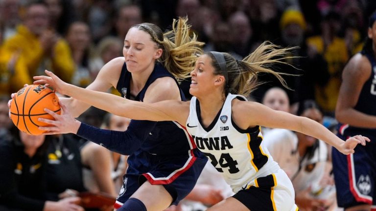 UConn guard Paige Bueckers fights for a loose ball with Iowa guard Gabbie Marshall during the first half of a Final Four college basketball game in the women's NCAA Tournament, Friday, April 5, 2024, in Cleveland. (Carolyn Kaster/AP Photo)