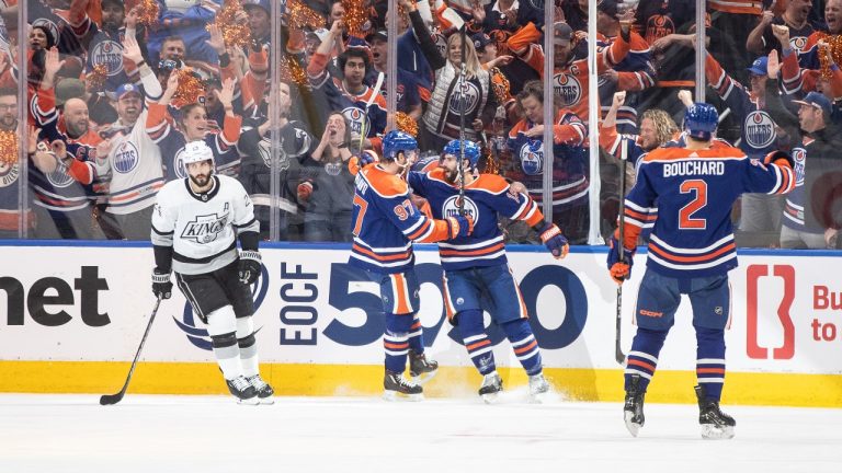 Los Angeles Kings' Phillip Danault (24) skates past the Edmonton Oilers' Connor McDavid (97), Adam Henrique (19) and Evan Bouchard (2) as they celebrate a goal during first period of Game 1 first round NHL Stanley Cup playoff hockey action in Edmonton, Monday, April 22, 2024. (Jason Franson/CP)