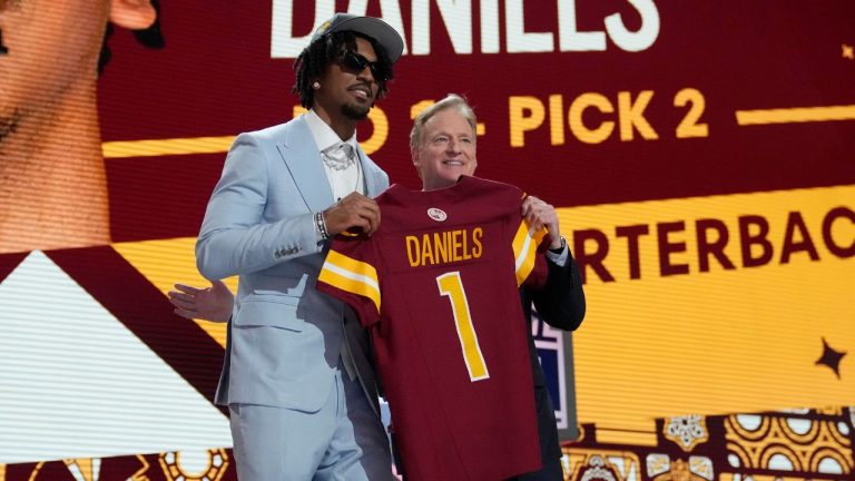 LSU quarterback Jayden Daniels poses with NFL commissioner Roger Goodell after being chosen by the Washington Commanders with the second overall pick during the first round of the NFL football draft, Thursday, April 25, 2024, in Detroit. (Jeff Roberson/AP Photo)