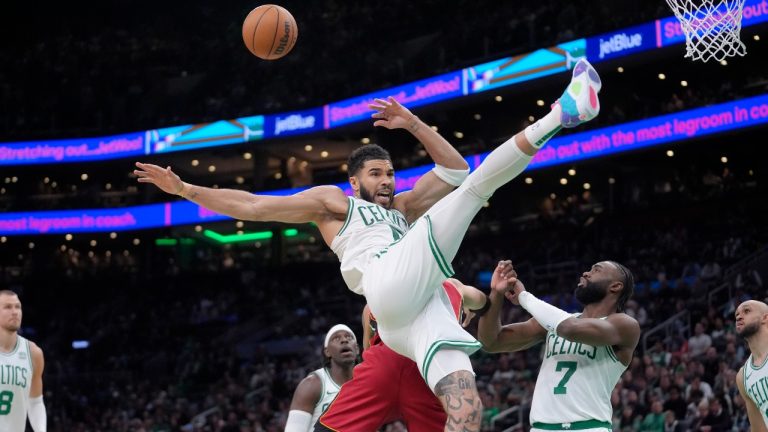 Miami Heat forward Caleb Martin, behind center, fouls Boston Celtics forward Jayson Tatum, front center, in front of Celtics guard Jaylen Brown (7) in the second half of Game 1 of an NBA basketball first-round playoff series, Sunday, April 21, 2024, in Boston. (AP Photo/Steven Senne)