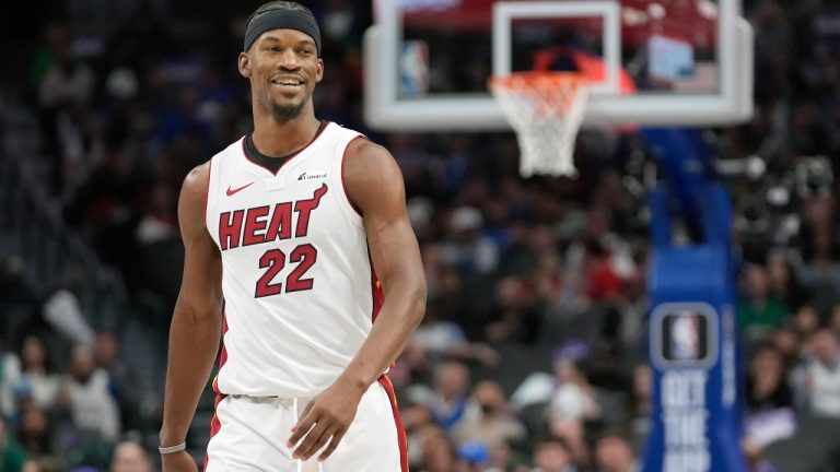 Miami Heat forward Jimmy Butler smiles as he walks the court during the first half of an NBA basketball game against the Dallas Mavericks in Dallas, Thursday, March 7, 2024. (AP Photo/LM Otero)