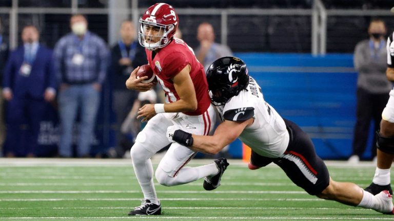 Alabama quarterback Bryce Young (9) is tackled by Cincinnati linebacker Joel Dublanko (41) during the first half of the Cotton Bowl NCAA College Football Playoff semifinal game, Friday, Dec. 31, 2021, in Arlington, Texas. (Michael Ainsworth/AP)