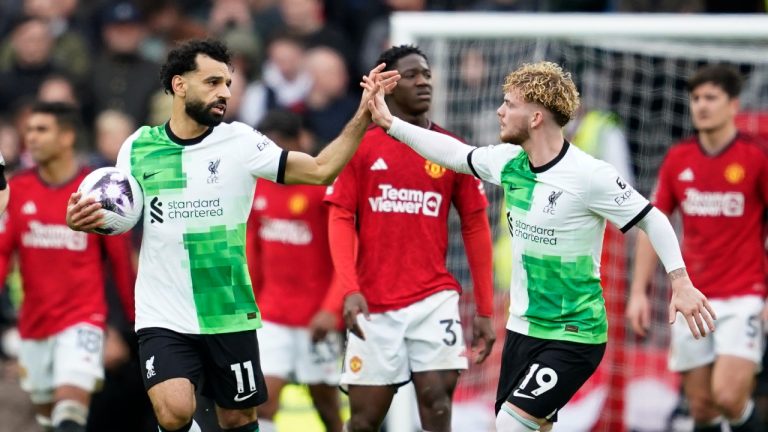 Liverpool's Mohamed Salah, centre left, celebrates with Harvey Elliott after scoring his side's second goal during the English Premier League soccer match between Manchester United and Liverpool at the Old Trafford stadium in Manchester, England, Sunday, April 7, 2024. (AP Photo/Dave Thompson)