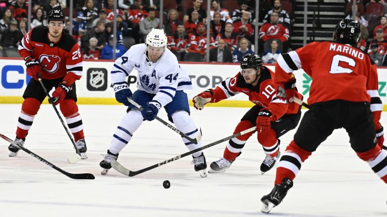 Toronto Maple Leafs defenceman Morgan Rielly (44) and New Jersey Devils right wing Alexander Holtz (10) chase after the puck during the first period of an NHL hockey game Tuesday, April 9, 2024, in Newark, N.J.(Bill Kostroun/AP)