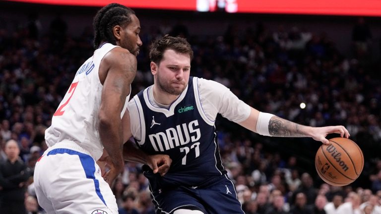 Dallas Mavericks' Luka Doncic (77) is defended by Los Angeles Clippers' Kawhi Leonard during the second half of Game 2 of an NBA basketball first-round playoff series in Dallas, Friday, April 26, 2024. (AP Photo/Tony Gutierrez)