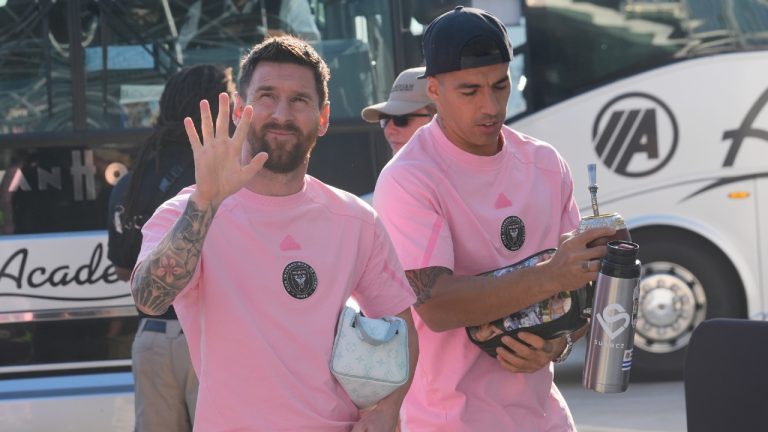 Inter Miami's Lionel Messi waves to fans as he arrives with Luis Suárez (9) and the rest of the team before an MLS soccer match against the Nashville SC, Saturday, April 20, 2024, in Fort Lauderdale, Fla. (Marta Lavandier/AP)