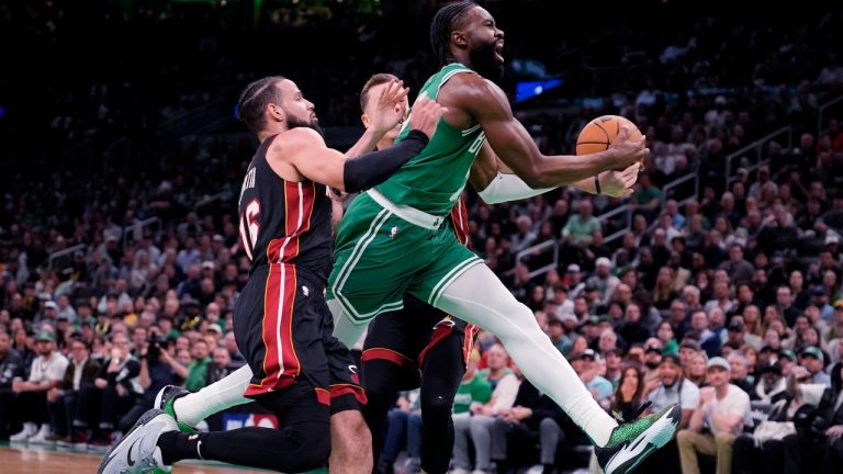 Boston Celtics guard Jaylen Brown, right, drives to the basket against Miami Heat's Caleb Martin (16) during the first half of Game 2 of an NBA basketball first-round playoff series, Wednesday, April 24, 2024, in Boston. (AP Photo/Charles Krupa)