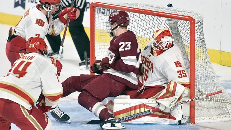 Denver goaltender Matt Davis made this save on Massachusetts' Scott Morrow (23) during the second period of a college hockey game in the NCAA Tournament, Thursday, March 28, 2024, Springfield, Mass.. (Don TreegerThe Republican via AP)