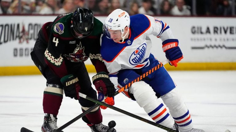 Edmonton Oilers centre Zach Hyman and Arizona Coyotes defenceman Juuso Valimaki vie for the puck during the second period of an NHL hockey game Wednesday, April 17, 2024, in Tempe, Ariz. (Ross D. Franklin/AP Photo)