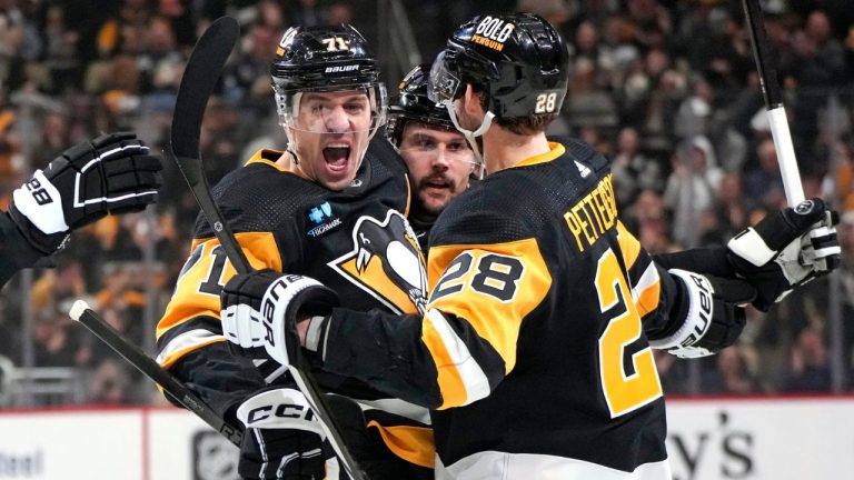 Pittsburgh Penguins' Evgeni Malkin celebrates his first of two goals in the second period with Erik Karlsson and Marcus Pettersson during an NHL hockey game against the Tampa Bay Lightning in Pittsburgh, Saturday, April 6, 2024. (Gene J. Puskar/AP Photo)