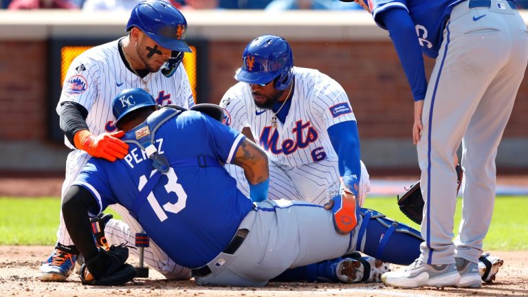 New York Mets' Francisco Alvarez and Starling Marte help Kansas City Royals catcher Salvador Perez (13) who injured on a play at the plate. (Noah K. Murray/AP)