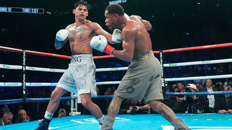 Ryan Garcia, left, punches Devin Haney during the 12th round of a super lightweight boxing bout early Sunday, April 21, 2024, in New York. (Frank Franklin II/AP)