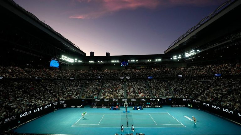 Daniil Medvedev of Russia, left, plays against Jannik Sinner of Italy at the sunset during the men's singles final at the Australian Open tennis championships at Melbourne Park, in Melbourne, Australia, Sunday, Jan. 28, 2024. (AP Photo/Alessandra Tarantino)