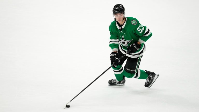 Dallas Stars centre Wyatt Johnston controls the puck during an NHL hockey game against the Vancouver Canucks in Dallas, Thursday, Dec. 21, 2023. (AP Photo/Tony Gutierrez)