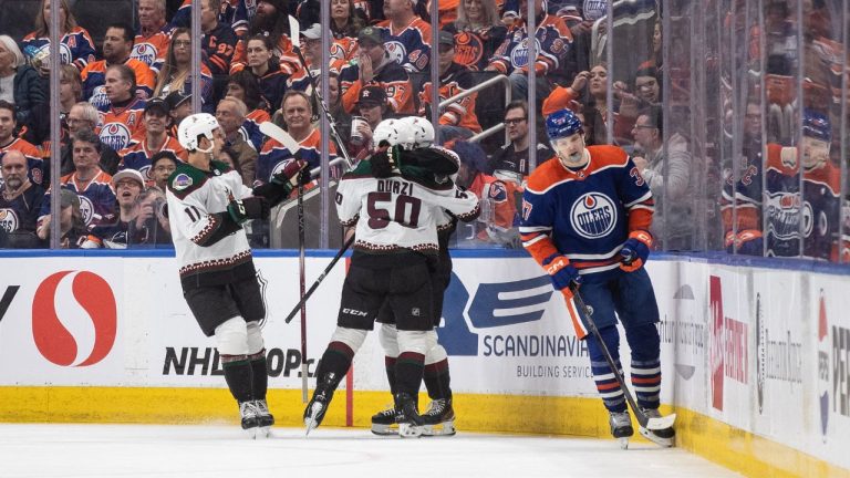 Arizona Coyotes' Dylan Guenther, Sean Durzi and Logan Cooley celebrate a goal as Edmonton Oilers' Warren Foegele skates past during second period NHL action in Edmonton on Friday April 12, 2024. (Jason Franson/CP Photo)