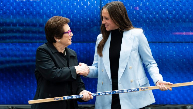 Minnesota's Tayler Heise, right, from NCAA shakes hands with former American tennis player Billie Jean King after being selected first overall during the first round of the inaugural Professional Women’s Hockey League draft in Toronto, on Monday, Sept. 18, 2023. (Spencer Colby/CP)