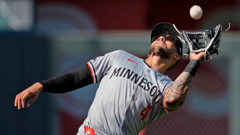 Minnesota Twins shortstop Carlos Correa (4) catches a fly ball for the out on Kansas City Royals' Salvador Perez during the second inning of a baseball game Saturday, March 30, 2024, in Kansas City, Mo. (Charlie Riedel/AP)