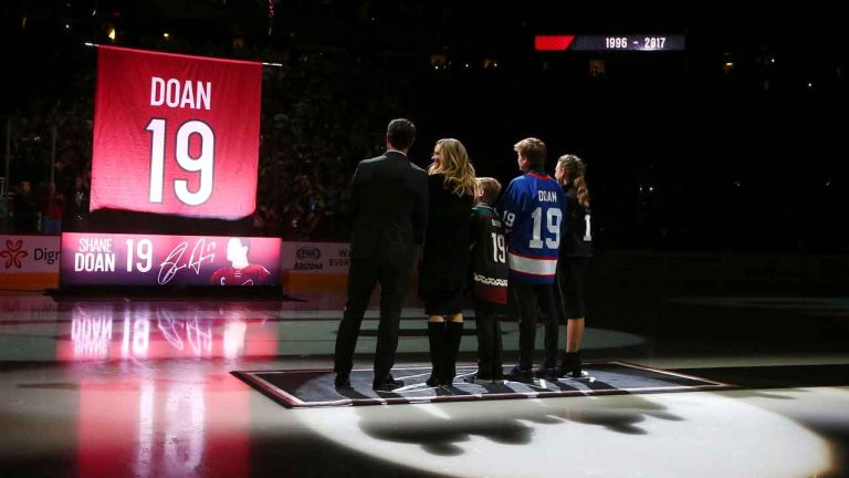 Shane Doan, left, wife Andrea Doan, children Carson Doan, Josh Doan, and Karys Doan, watch as the Arizona Coyotes retire Shane's jersey during a ceremony prior to an NHL hockey game. (Ross D. Franklin/AP)