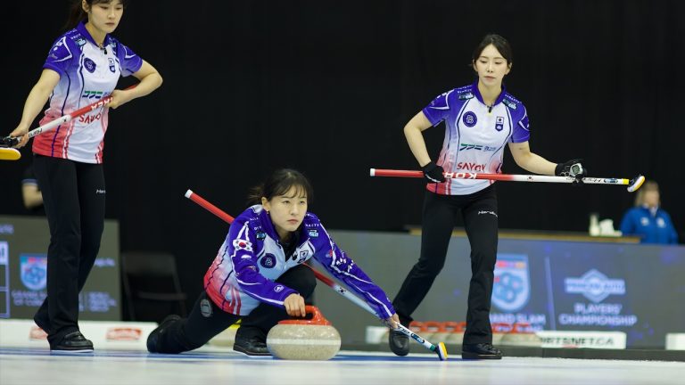 Eunji Gim (centre) delivers a rock during the Princess Auto Players' Championship on Saturday, April 13, 2024, in Toronto. (Anil Mungal/GSOC)