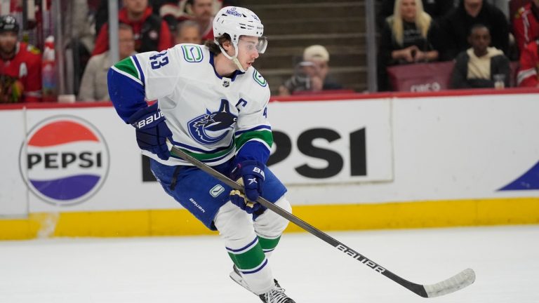 Vancouver Canucks defenceman Quinn Hughes handles the puck during the first period of a hockey game against the Chicago Blackhawks, Tuesday, Feb. 13, 2024, in Chicago. (Erin Hooley/AP)