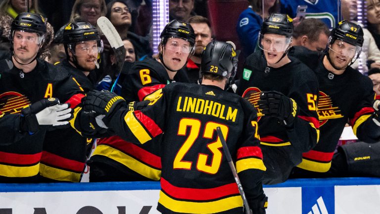 Vancouver Canucks' Elias Lindholm (23) celebrates his goal with his teammates during the first period of an NHL hockey game against the Detroit Red Wings, in Vancouver on Thursday, Feb. 15, 2024. (Ethan Cairns/CP)