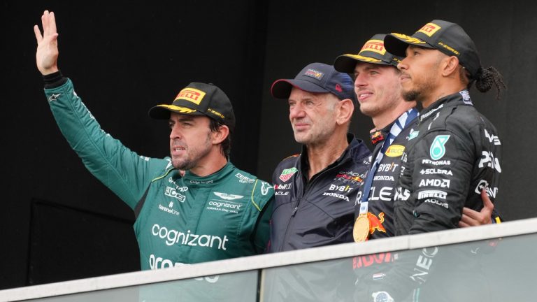 Second place finisher Aston Martin driver Fernando Alonso, left to right, of Spain, Adrian Newey, Red Bull Racing chief technology officer, and winner Max Verstappen of the Netherlands and third place finisher Mercedes driver Lewis Hamilton of Great Britain celebrate on the podium following the Canadian Grand Prix Sunday, June 18, 2023 in Montreal. (Christinne Muschi/CP)