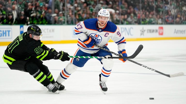 Dallas Stars center Tyler Seguin (91) works against Edmonton Oilers' Connor McDavid (97) as they compete for the puck in the first period of an NHL hockey game, Wednesday, April 3, 2024, in Dallas. (Tony Gutierrez/AP)