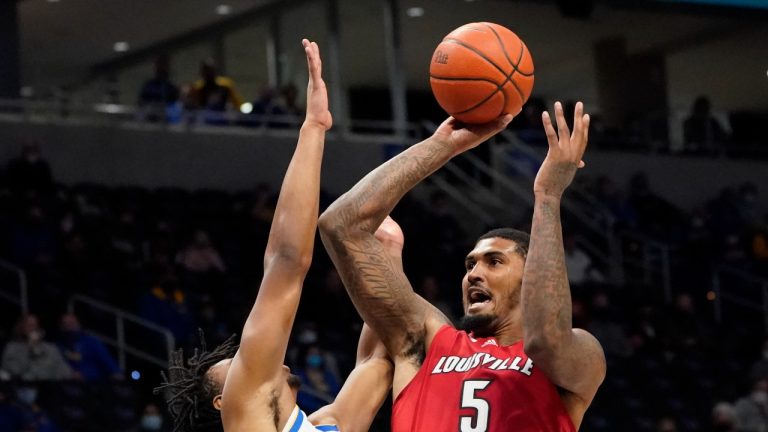 Louisville's Malik Williams (5) shoots over Pittsburgh's Noah Collier, left, during the first half of an NCAA college basketball game, Saturday, Jan. 15, 2022, in Pittsburgh. (Keith Srakocic/AP Photo)