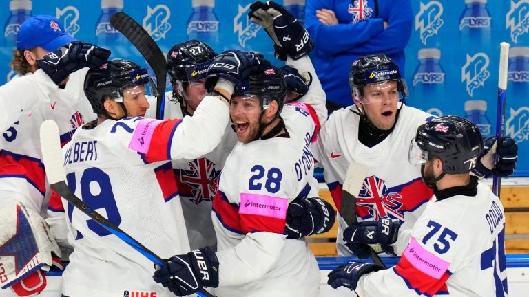 Britain's Ben O'Connor, centre, celebrates with teammates after scoring his sides first goal during the preliminary round match between Austria and Great Britain at the Ice Hockey World Championships in Prague, Czech Republic, Tuesday, May 21, 2024. (Petr David Josek/AP)