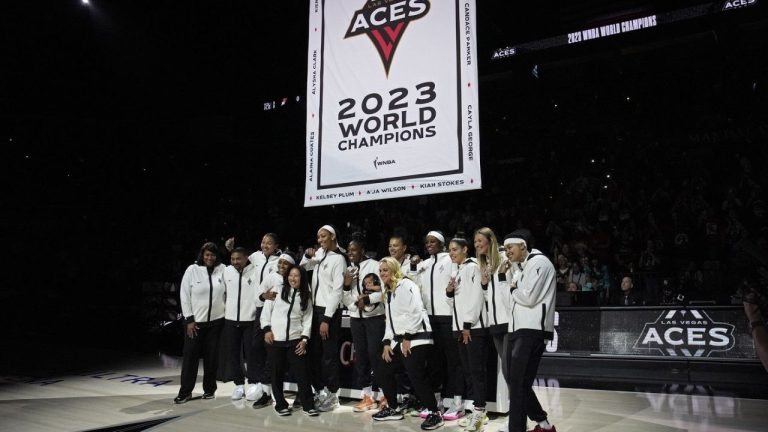 Las Vegas Aces players pose as they raise the 2023 championship banner before a WNBA basketball game Tuesday, May 14, 2024, in Las Vegas. (John Locher/AP Photo)